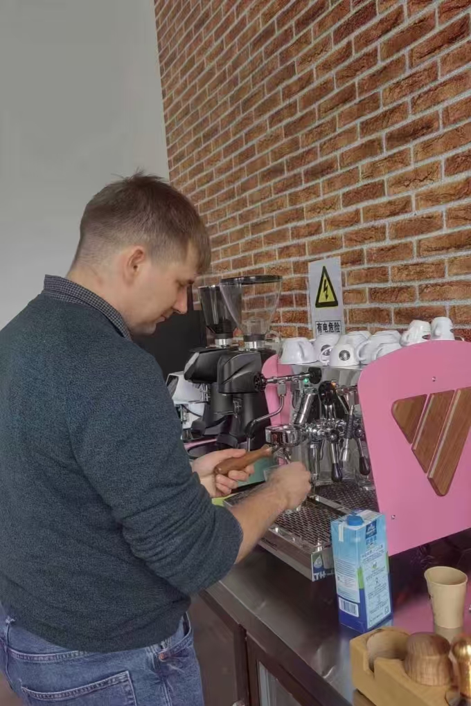 Barista working on espresso machine and barista gear, preparing for barista supplies wholesale business